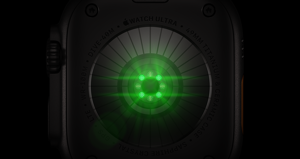 Parte posterior de un Apple Watch Ultra 4, caja de titanio, color negro, varios sensores redondos con luces LED verdes brillantes