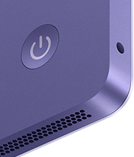 iMac, parte posterior, color morado, se muestran el botón de encendido, la entrada para audífonos y la rejilla de la bocina